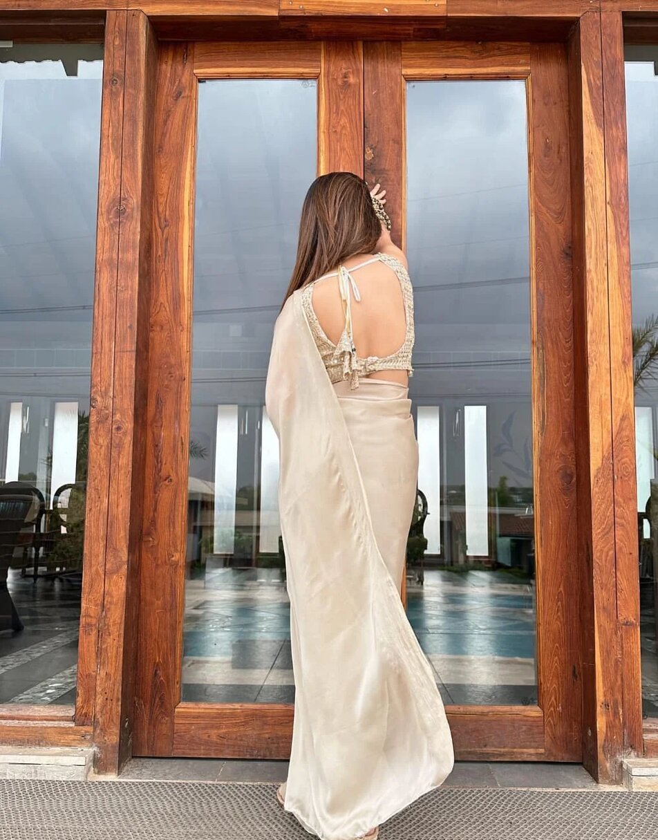 Tan gold laser georgette saree with oat golden blouse